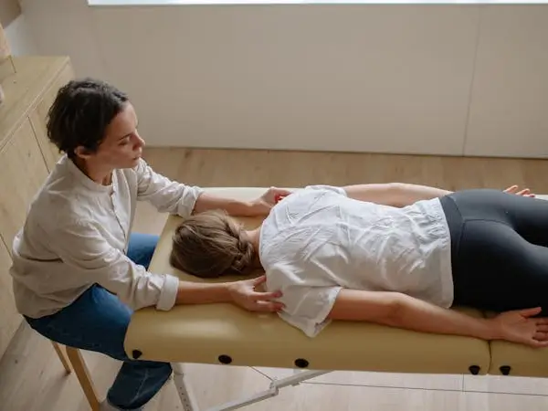 Woman having her back assessed